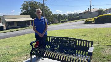 President of Rotary Club Kempsey West Judy Beilby stands proudly with the club's commemorative seat at the East Kempsey memorial site. Picture by Ellie Chamberlain