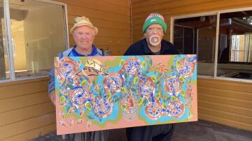 Kinchela Boys Home survivors (L-R) Uncle James Michael 'Widdy' Welsh and Uncle Richard Campbell hold an artwork created by Uncle Richard for the 100th Anniversary. Picture by Ellie Chamberlain